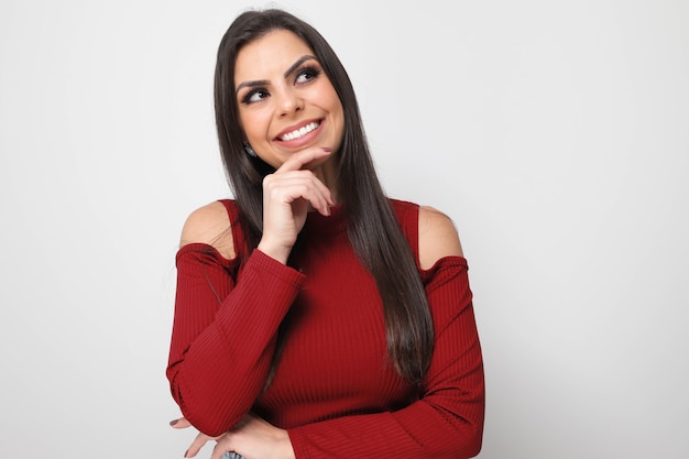 Beautiful girl holding valentine's gift on white background.