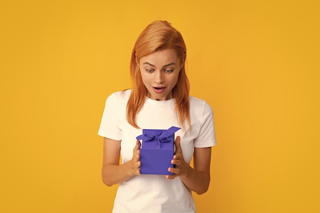 Beautiful girl holding valentines gift Happy birthday celebration woman day christmas Woman holding gift box and rejoices