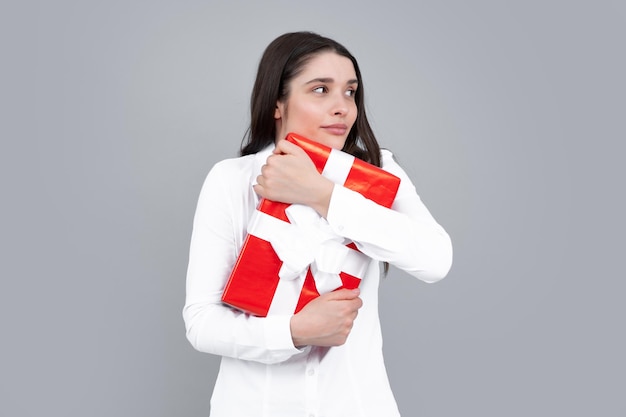 Beautiful girl holding valentines gift Happy birthday celebration woman day christmas Woman holding gift box and rejoices