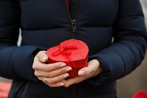 Beautiful girl holds a box with a gift in her hands