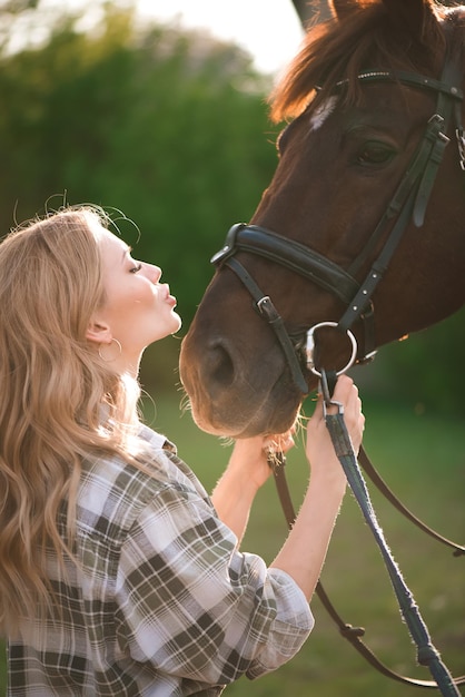 Beautiful girl and a horse Chestnut horse together with her favorite owner young teenage girl