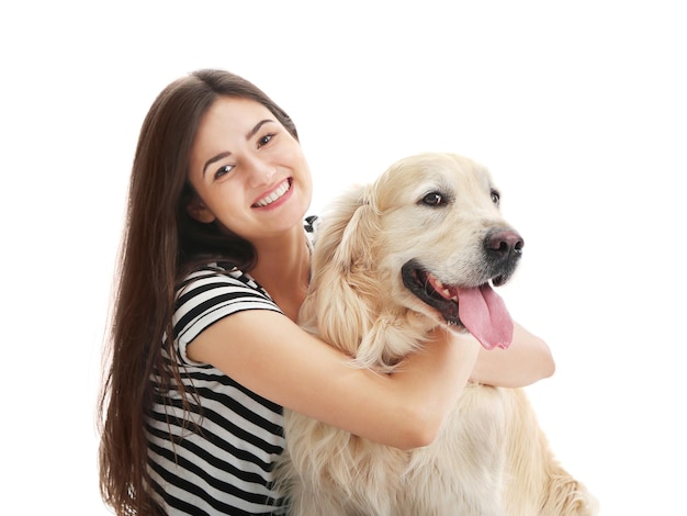 Beautiful girl hugging retriever isolated on white