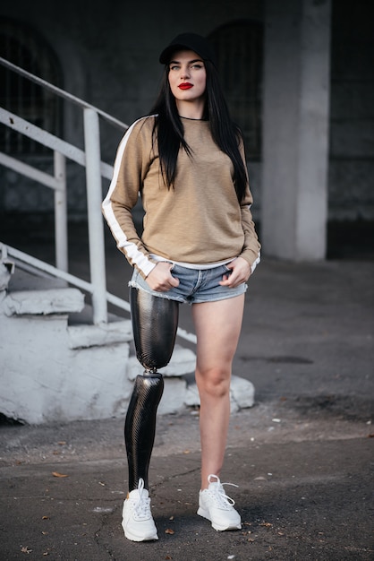 A beautiful girl is disabled with a prosthesis on one leg.