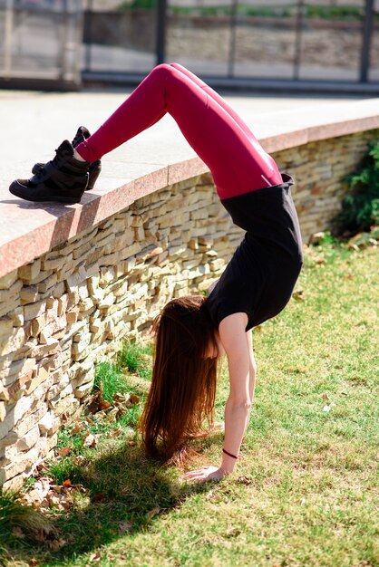 A beautiful girl is engaged in choreography in nature.