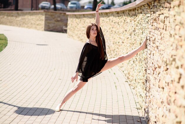 A beautiful girl is engaged in choreography in nature.