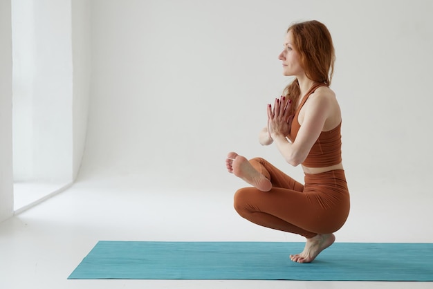 A beautiful girl is engaged in a yoga studio