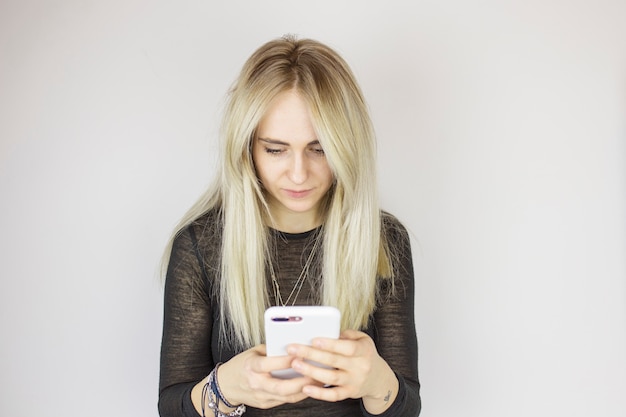 Beautiful girl is typing a message on the smartphone