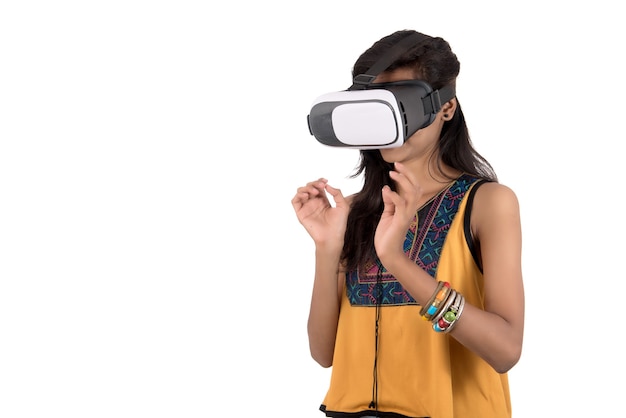 Красивая девушка смотрит устройство VR. Молодая девушка носить гарнитуру очки виртуальной реальности.