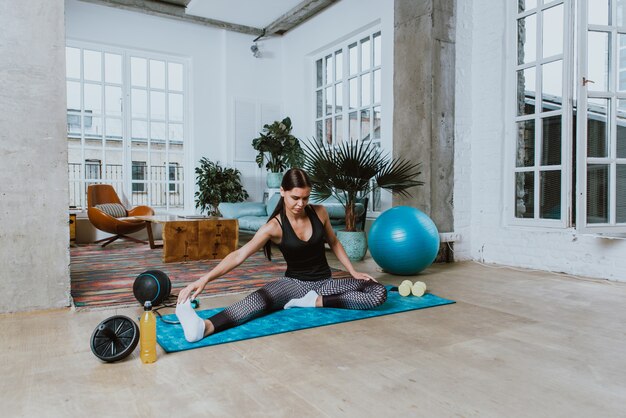 Beautiful girl making training and yoga at home in the morning