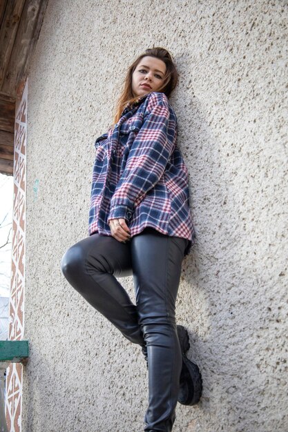 Beautiful girl near the stone wall