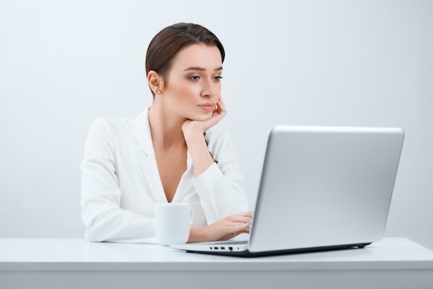 Beautiful girl in the office working on the computer