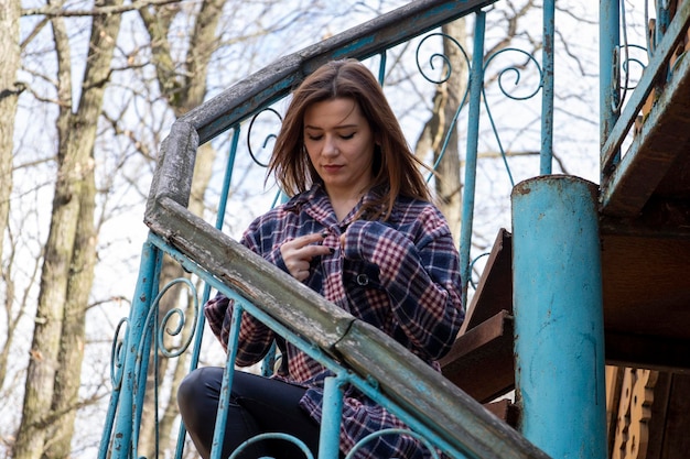 Beautiful girl on the old metal steps.