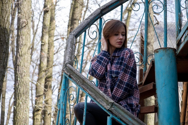 Beautiful girl on the old metal steps.