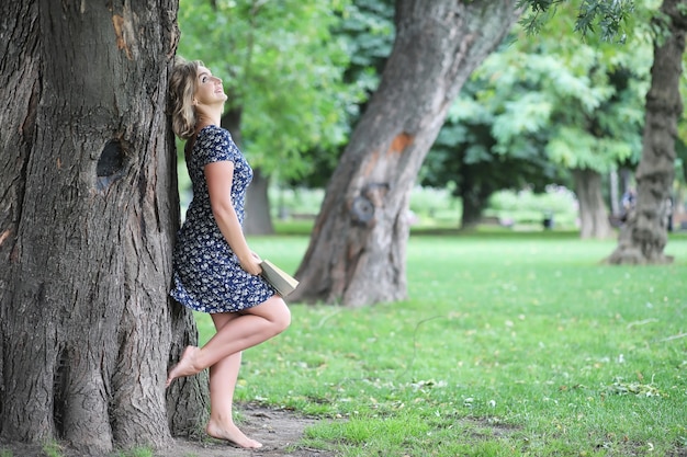 Beautiful girl in the park on a summer sunny day walk