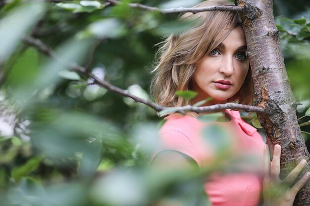 Beautiful girl in the park on a summer sunny day walk