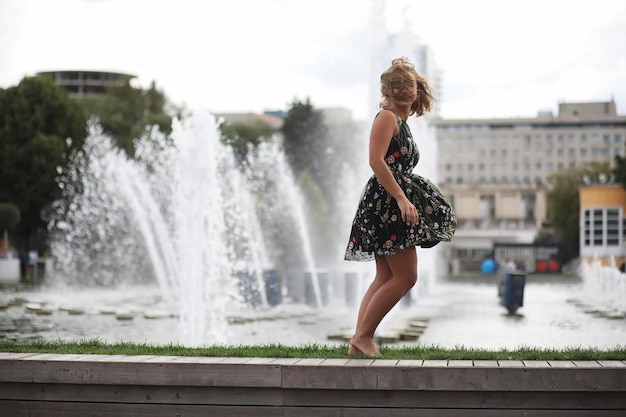 Beautiful girl in the park on a summer sunny day walkxA