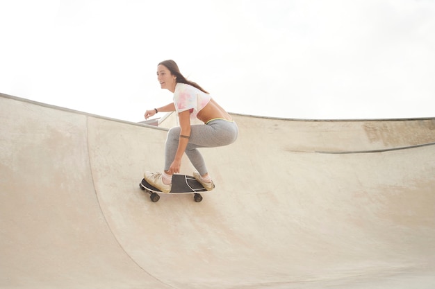 Beautiful girl in the park with a skateboard