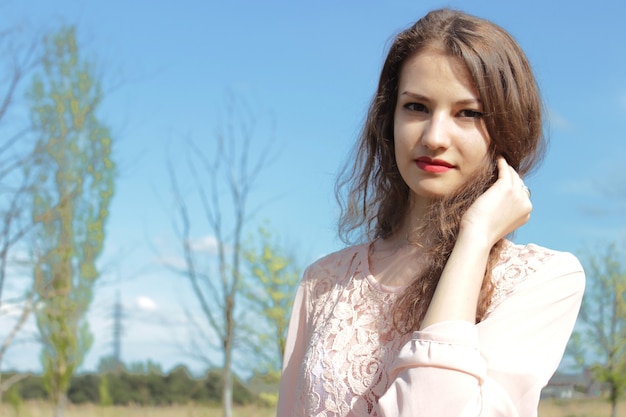 Beautiful girl in a pink dress in field.