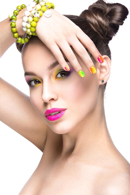 Beautiful girl in pink sunglasses with bright makeup and colorful nails Beauty face Picture taken in the studio on a white background