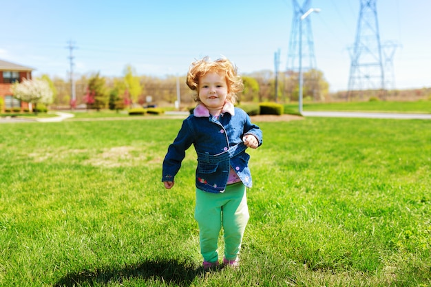 Beautiful girl playing in the street in the spring