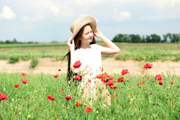 Beautiful girl in poppy field