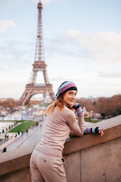 エッフェル塔パリの背景にポーズをとって美しい少女