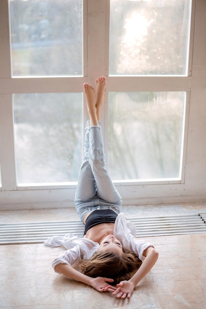 Beautiful girl posing in front of the window