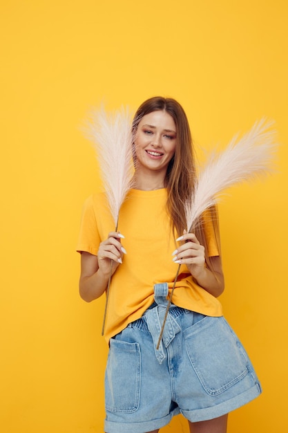 Beautiful girl posing pink feathers in hands charm fashion yeah Lifestyle unaltered