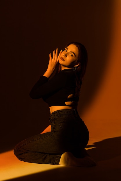 Beautiful girl posing in the studio on a dark background