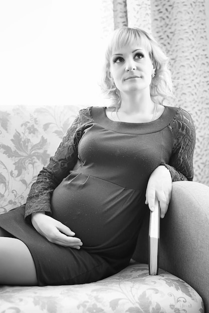 Beautiful girl pregnant blonde prepares to become a mom