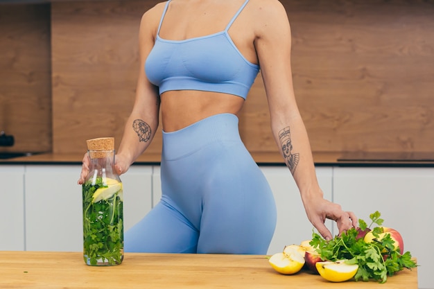 Beautiful girl prepares healthy food in the kitchen