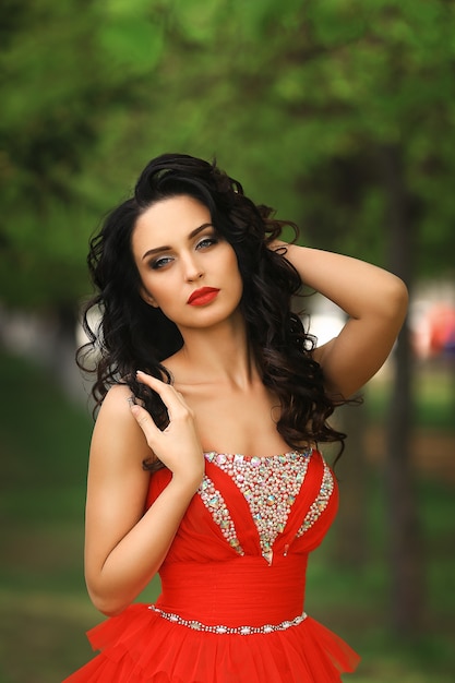 Beautiful girl in the red dress in the park.