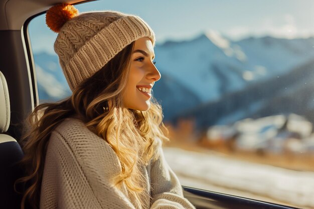beautiful girl rides in a car in the mountains in winter traveling on vacation