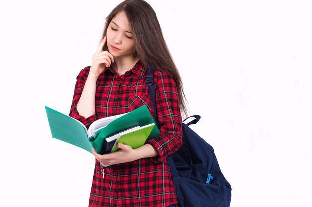 Beautiful girl schoolgirl, student with textbooks and backpack