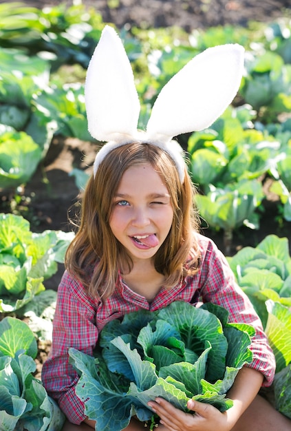 Beautiful girl sitting in a cabbage field