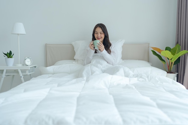 Beautiful girl sitting and drinking hot tea in the morning