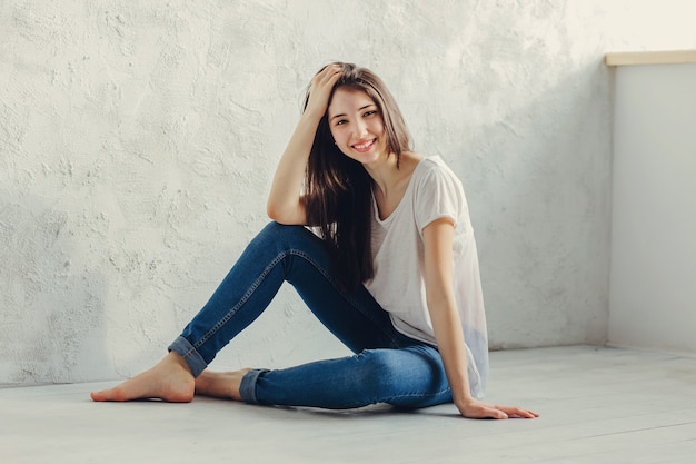 Beautiful girl sitting on the floor