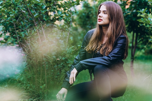 Beautiful girl sitting on a grass