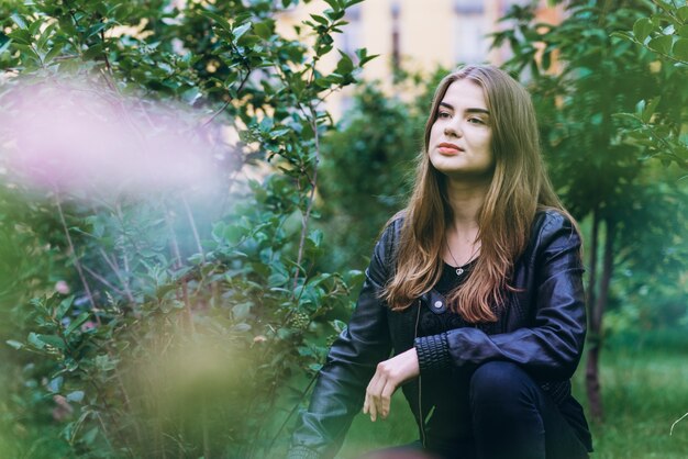 Beautiful girl sitting on a grass