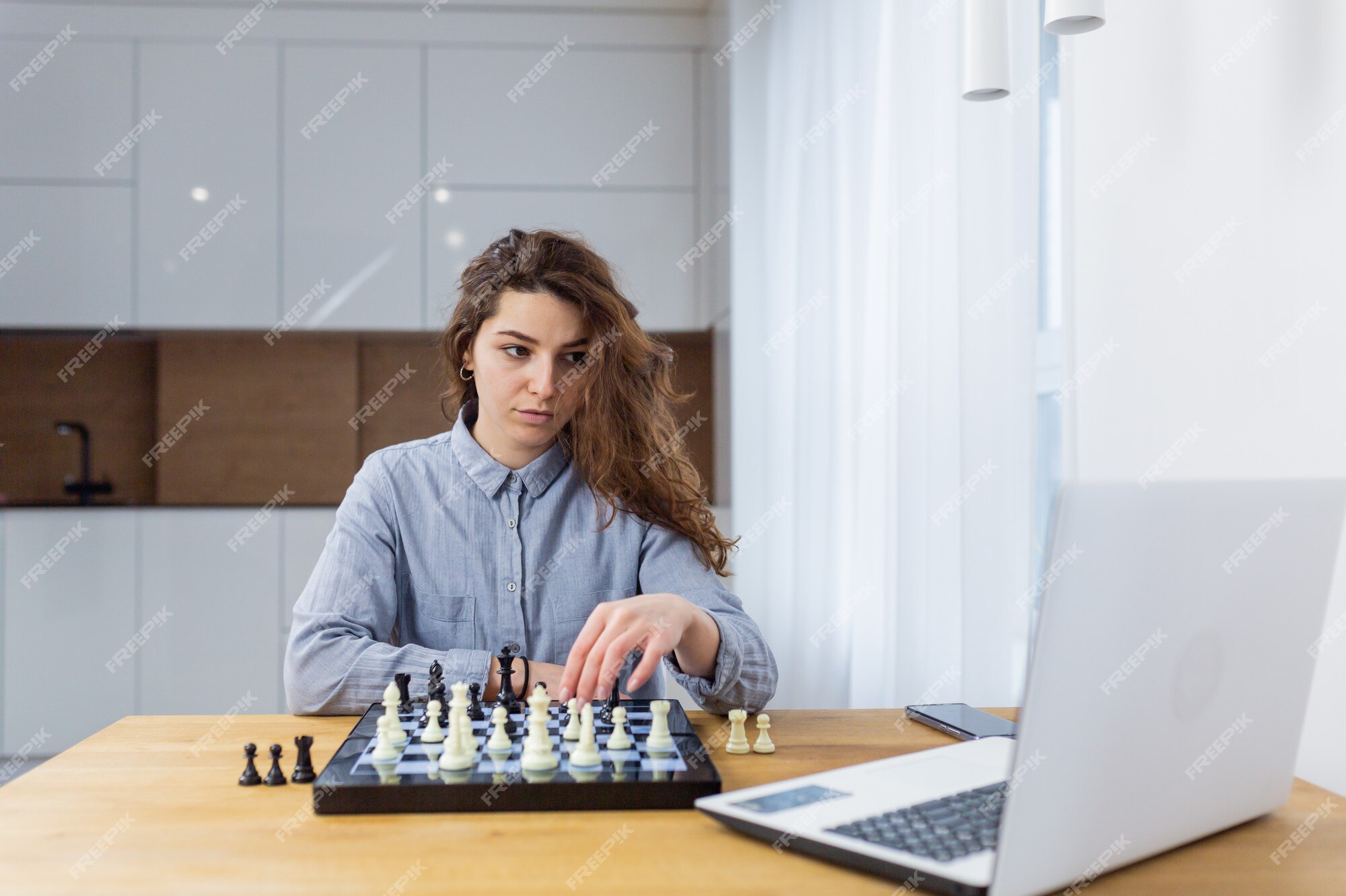 Premium Photo  Girl playing chess online on tablet computer