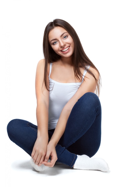 Beautiful girl sitting on a white background isolated