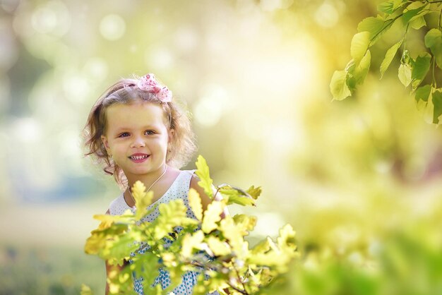 Beautiful girl smiling from behind a bush