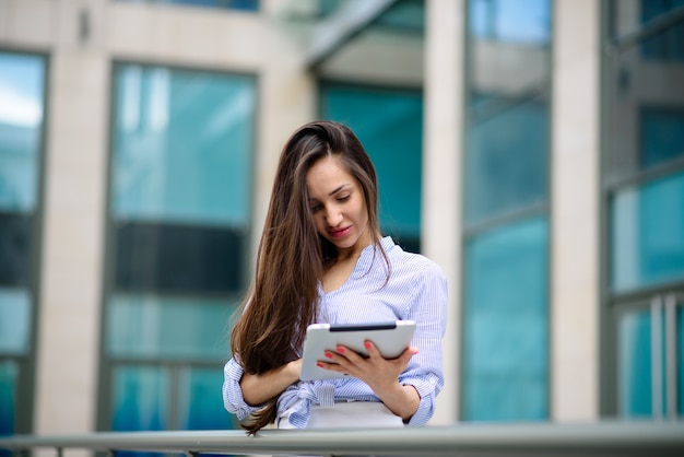 Beautiful girl smiling and running on a tablet.