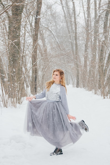 Beautiful girl under the snowfall