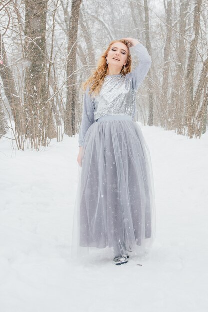 Beautiful girl under the snowfall