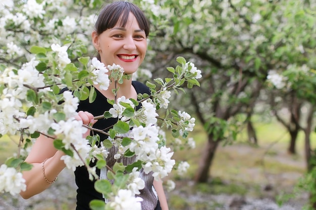 Beautiful girl in the spring afternoon in a park with children