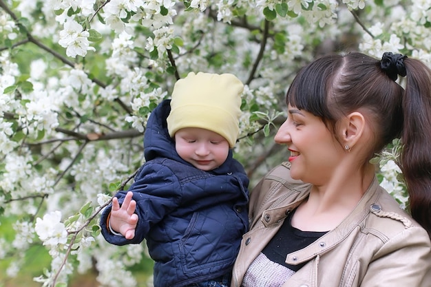 Beautiful girl in the spring afternoon in a park with children