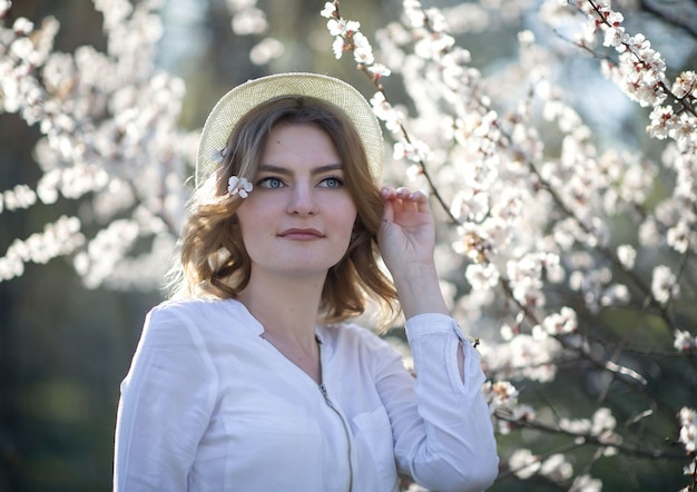 Beautiful girl in the spring in the park in a hat