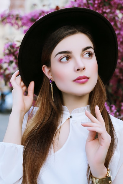 Beautiful girl in spring pink blossom