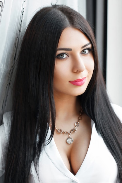 Beautiful girl standing at the window